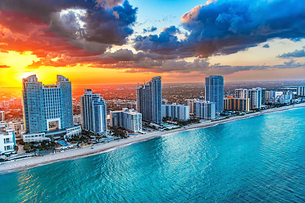 Aerial view of the hotels and luxury condominiums along the beach in Hollywood, Florida located between Miami and Fort Lauderdale shot via helicopter at sunset from an altitude of about 900 feet over the Atlantic Ocean.