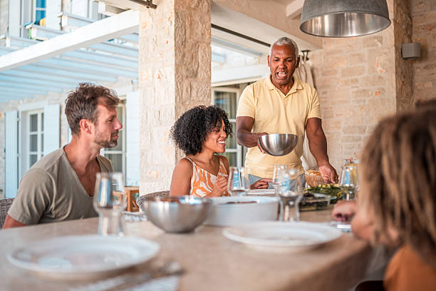 istock Diverse Multigeneration Family Sitting at Table Outdoors in Villa 2224971651