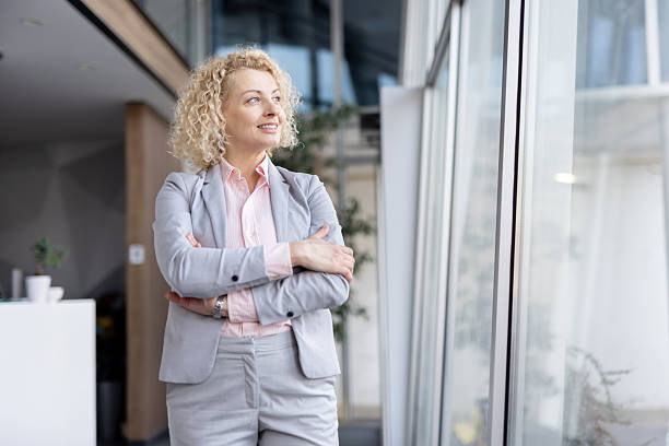Professional woman gazing thoughtfully out the window
