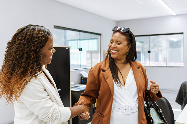istock Two businesswomen shaking hands at office 2224973928