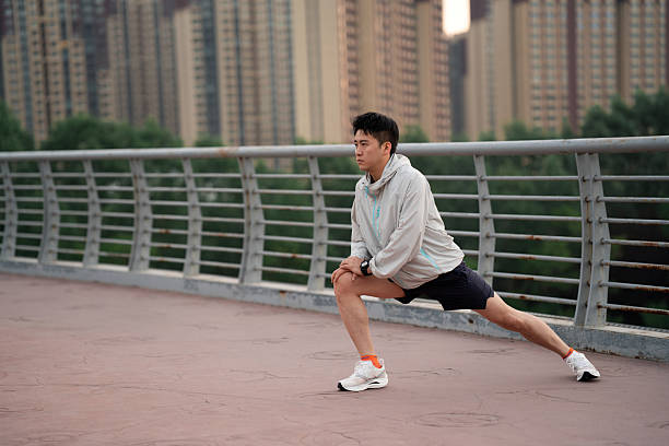 Asian man stretching and getting ready to go for run