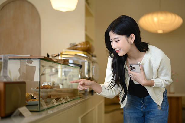 istock Young woman choosing dessert at a bakery counter 2224991047