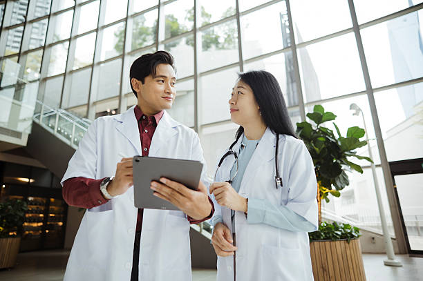 istock Medical Team Synchronizing Patient Information Digitally 2224991148