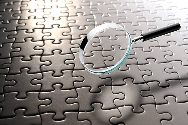 istock Magnifying glass floating in mid-air over the blank jigsaw puzzle 2224995964