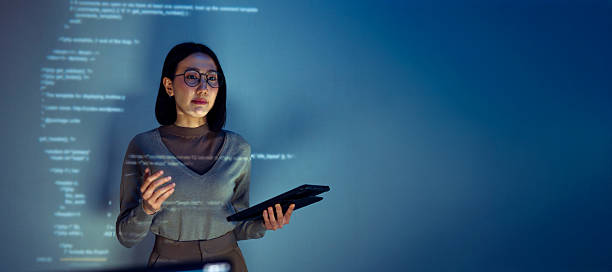 istock asian woman programmer standing in front of a screen with code projected  presentation the integration of technology and human expertise in software development 2224999368