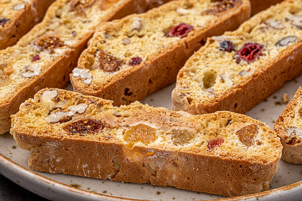 istock Italian Almond Biscotti biscuits in a rustic home made pottery bowl. Studded with almonds and cranberries, these twice-baked treats are aromatic and inviting. Ideal. 2225000599