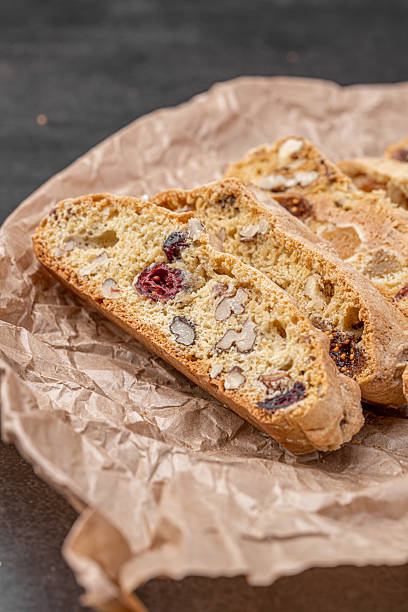istock Italian Almond Biscotti biscuits in a rustic home made pottery bowl. Studded with almonds and cranberries, these twice-baked treats are aromatic and inviting. Ideal. 2225000610