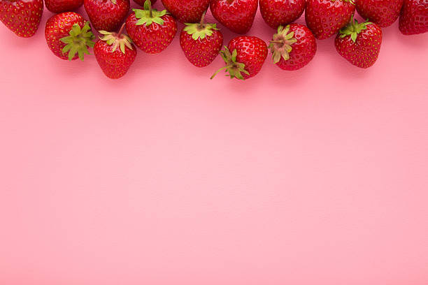 istock Red bright strawberries on light pink table background. Pastel color. Fresh berries. Closeup. Empty place for text. Top down view. 2225000703