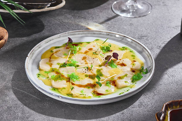 istock Scallop carpaccio in citrus sauce, bright lighting, overhead composition 2225002467