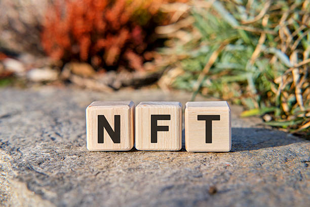 istock NFT - text on cubes standing on a stone on a natural background 2225004471