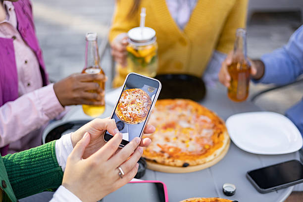 istock Friends Enjoying Pizza Outdoors 2225007865