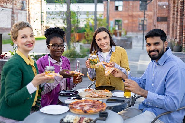 istock Friends Enjoying Pizza Outdoors 2225007894