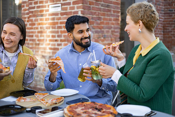 istock Friends Sharing Pizza Outdoors 2225007907