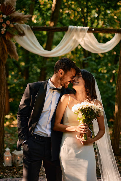 istock Happy Couple Smiling During Wedding Ceremony in the Woods 2225009183