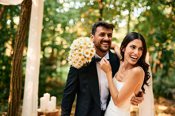 istock Happy Couple Smiling During Wedding Ceremony in a Forest 2225009274