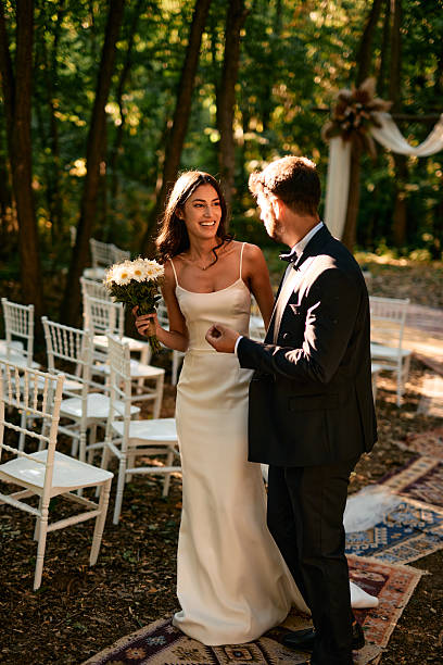 istock Bride and groom looking at each other during wedding ceremony in the forest 2225009309