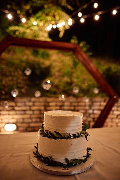 istock Elegant white wedding cake displayed on a table at an outdoor reception 2225009356