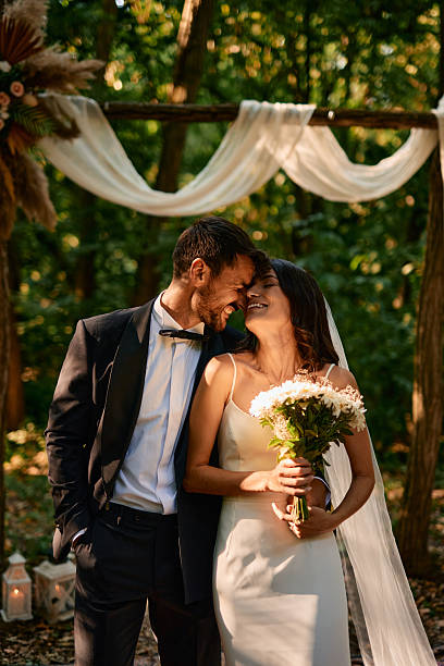 istock Happy Couple Smiling During Wedding Ceremony in the Woods 2225009571