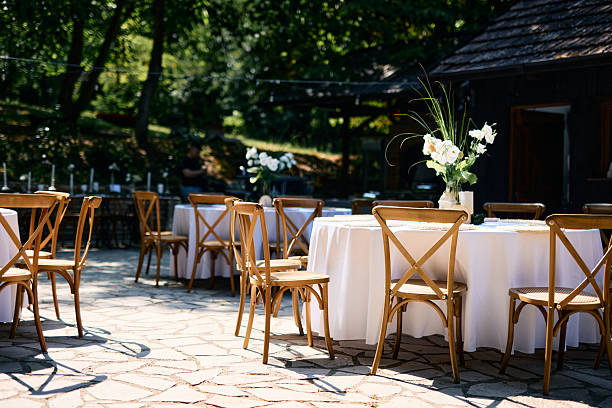 istock Round tables and cross-back chairs arranged for an outdoor wedding reception 2225009933