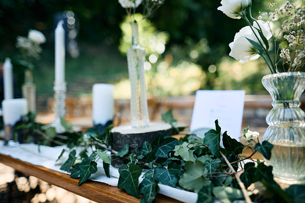 istock Decorating a wedding table with ivy, candles and white flowers 2225009964