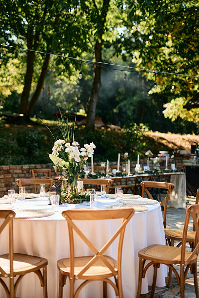 istock Wedding reception tables setting up in a beautiful garden 2225010055