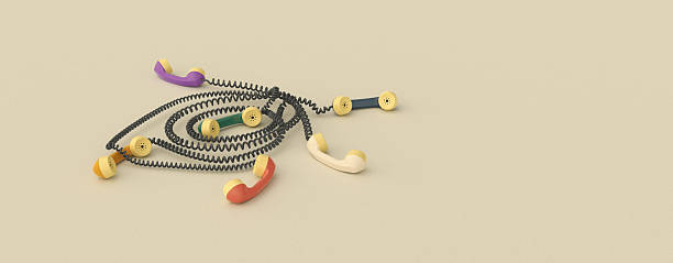 istock Retro Colorful Telephone Handsets with Tangled Cords and Copy Space on Beige Background 2225010214