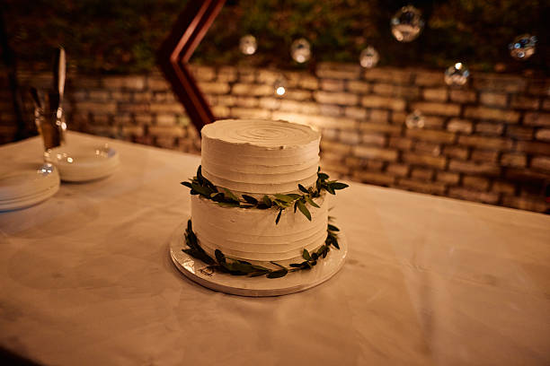 istock Elegant two-tiered wedding cake decorated with olive branches 2225010635