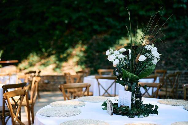 istock Wedding reception table setting with white flowers and greenery centerpiece 2225010668