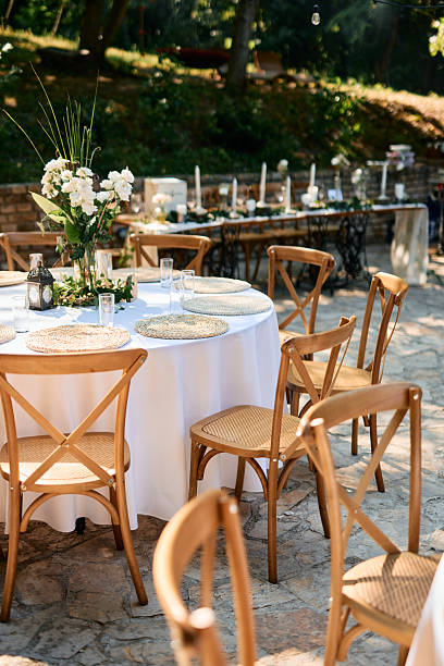 istock Wedding reception tables and chairs waiting for guests in a garden 2225010761