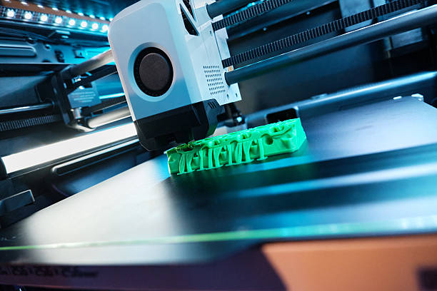 istock 3D Printer Creating a Detailed Object in a Modern Workspace With Blue Lighting and a Sleek Design 2225012040