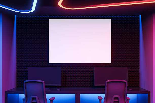 istock Futuristic gaming studio room with two chairs, dual monitors, neon lighting, and blank screen on acoustic wall in vibrant glowing environment. 3D Rendering 2225012215