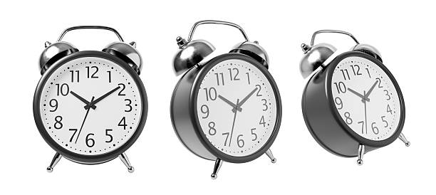 istock Three classic twin-bell alarm clocks shown in different time settings, isolated on white background, representing time management concept. 3D Rendering 2225012364