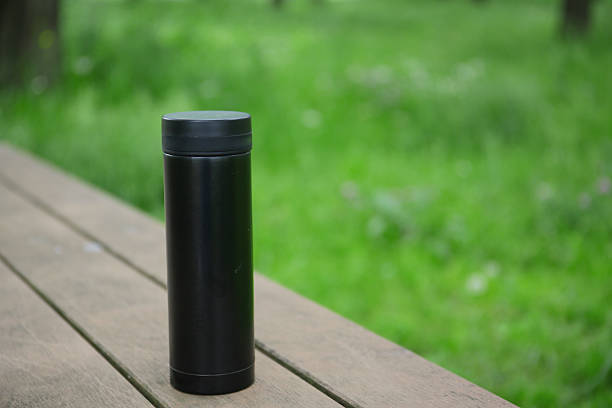 istock a mug on a wooden table in a park 2225012857