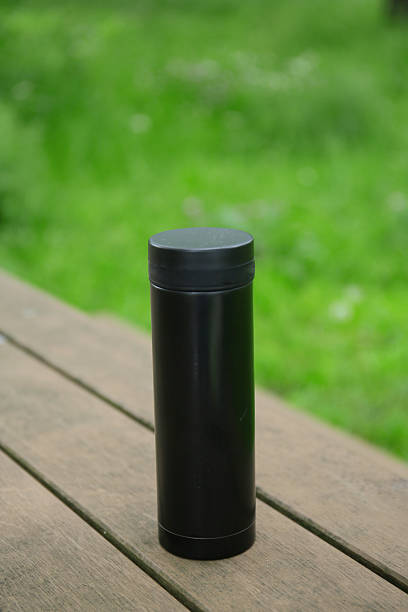 istock a mug on a wooden table in a park 2225012860
