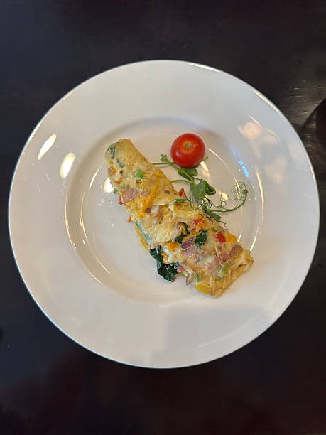 istock Gourmet omelette with cheese, ham, spinach, and peppers 2225013503