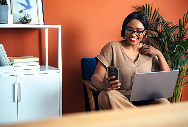 istock Smiling Professional Working From Home With Laptop and Smartphone 2225013890