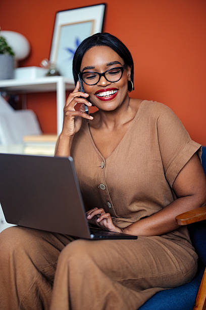 istock Woman Working Remotely Using Laptop and Phone in Cozy Home Office 2225013895