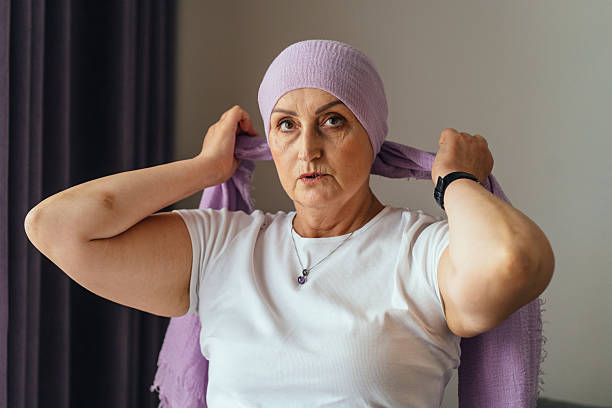 istock Focused woman tying lilac scarf with confidence 2225015633