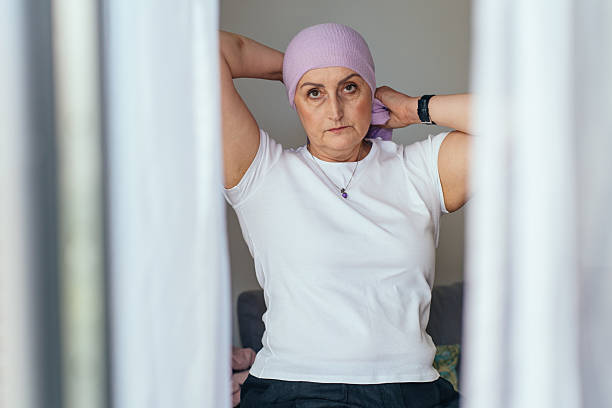 istock Reflective woman tying scarf viewed through curtains 2225015661
