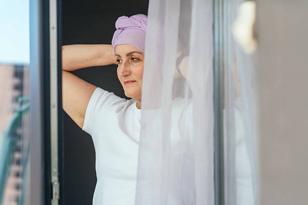 istock Recovered woman looking outside with soft smile 2225015675