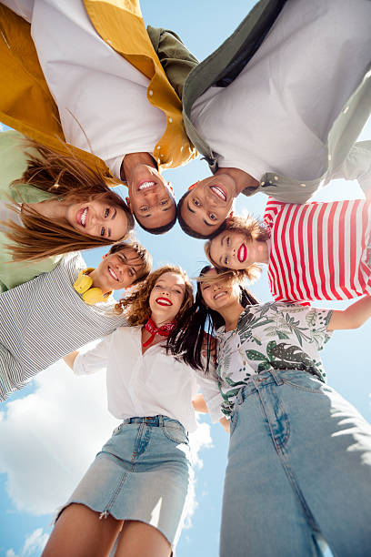 istock Diverse group of young friends bonding outdoors while enjoying a sunny day 2225015909