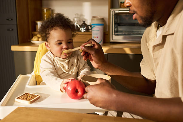 istock Young Black Father Feeding Infant Child While Bonding during Paternity Leave 2225017291