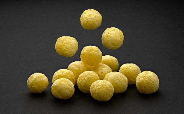 istock Falling corn balls isolated on black background, full depth of field 2225018363