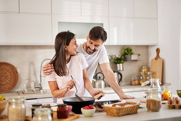 istock Happy couple cooking together in modern kitchen 2225018934