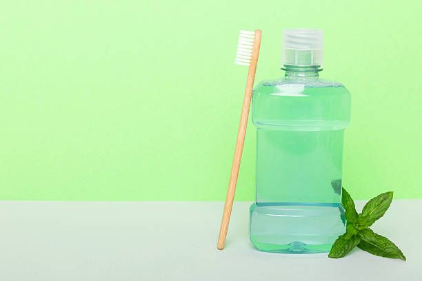 istock Mouthwash and fresh mint on colored background, top view with copy space for text 2225026032