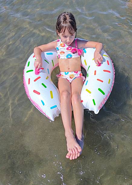 Little girl on inflatable donut shaped ring