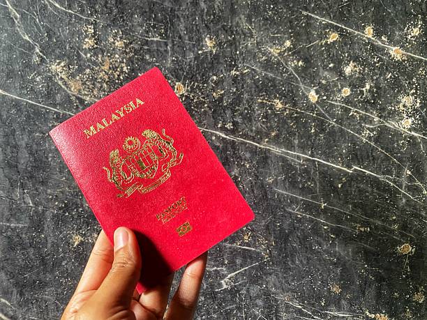 istock Person holding Malaysia passport. 2225029997