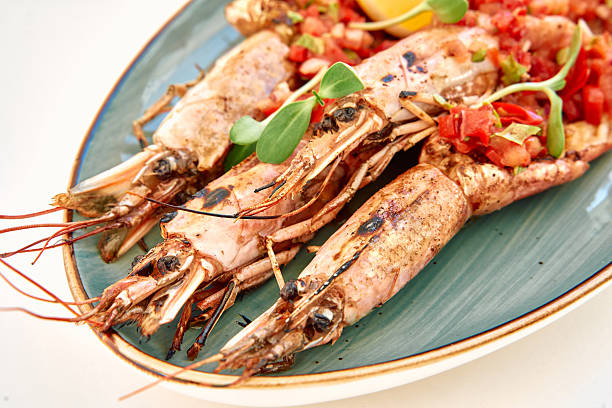 istock Grilled shrimp with fresh salsa on a green serving plate: a seafood delight 2225031613