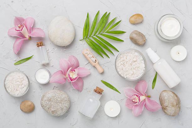 istock Composition with orchids and massage stones on concrete background, top view 2225033707
