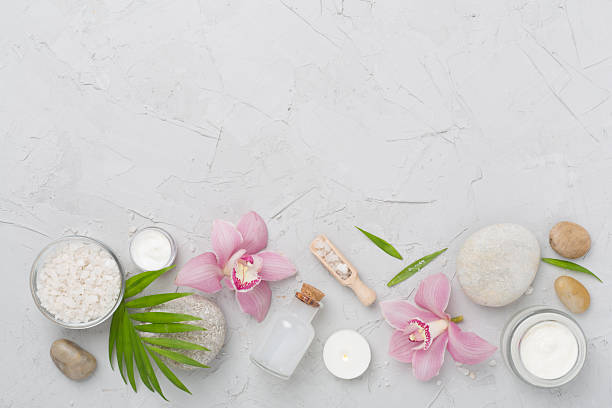 istock Composition with orchids and massage stones on concrete background, top view 2225033717